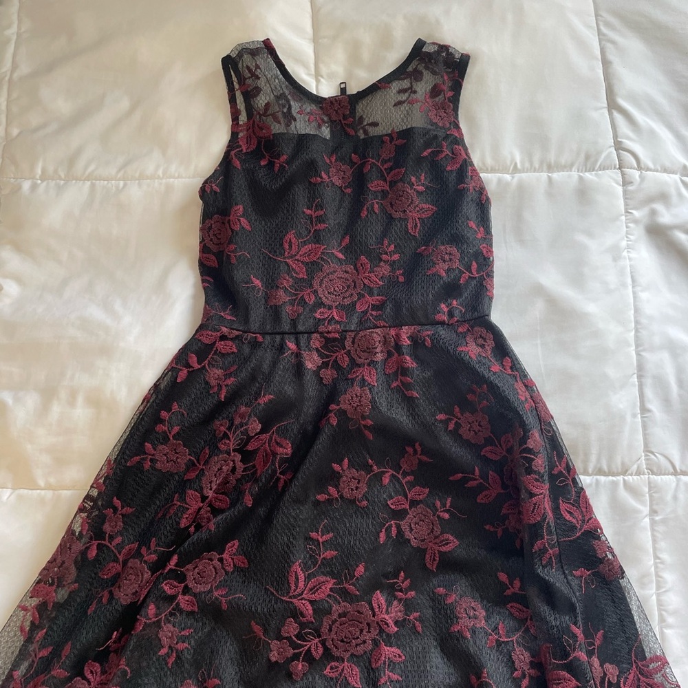 Black dress with red floral detailing.